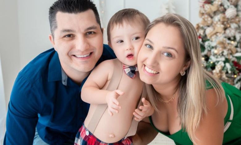 Mãe e pai ao lado do filho com síndrome de Down.